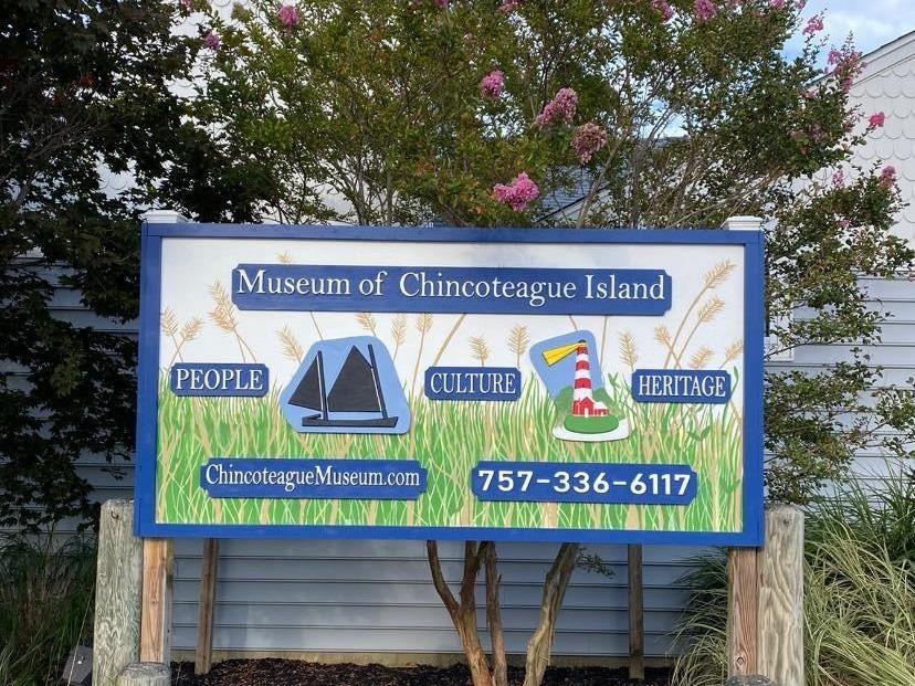 A large blue sign for the Museum of Chincoteague Island