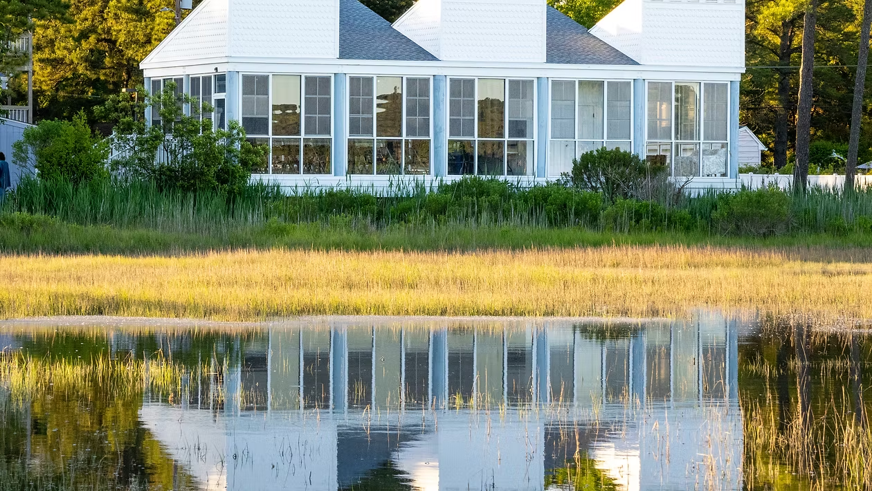 White house with windows on the water